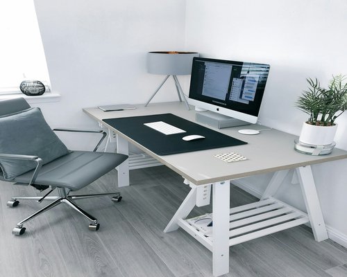 Minimalist desk setup with laptop and ergonomic chair