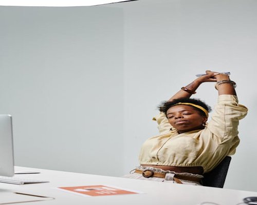 Stretching slightly while working at the desk