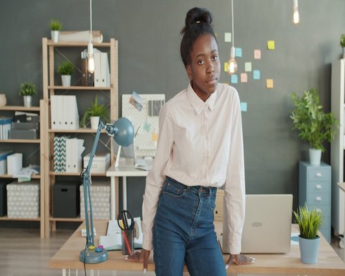 Person doing light stretching near an office desk